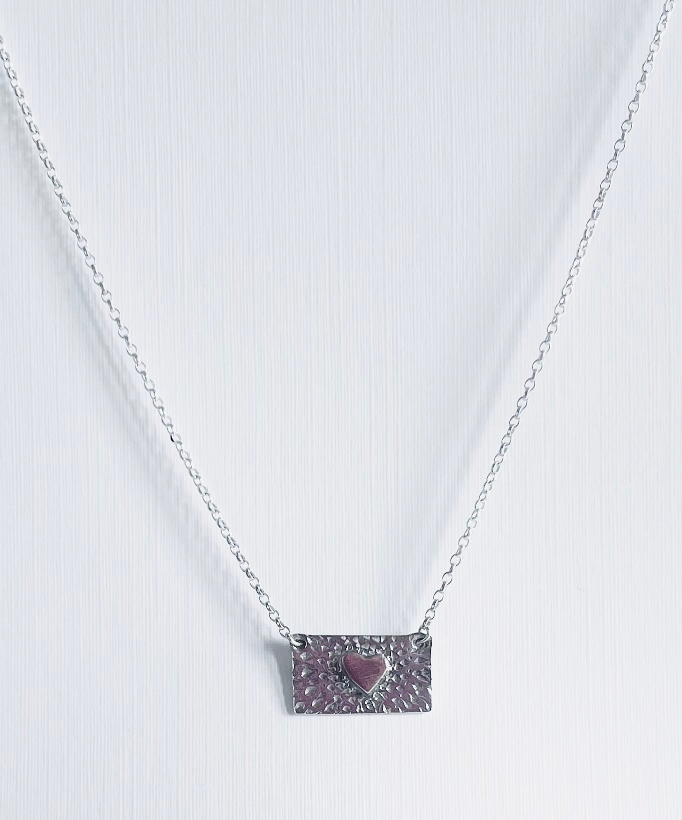 Gold heart on silver necklace