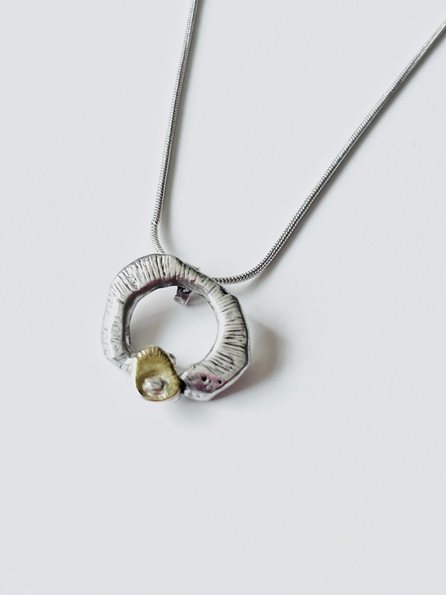 Gold and silver ripple pendant